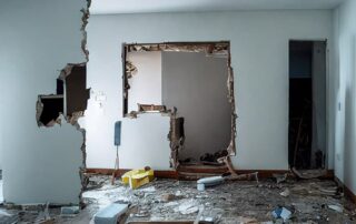 Room under construction with damaged walls.