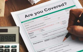 Completing insurance coverage form with a calculator nearby with ARC Restoration