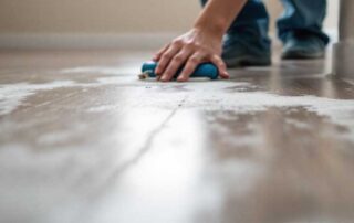 Close-up view of subfloor moisture damage causing buckling and warped flooring, with visible swelling and uneven boards. Image illustrates hidden water intrusion for the topic “Subfloor Moisture and Buckling Floors: Assessment to Restoration,” highlighting the need for evaluation and repair.