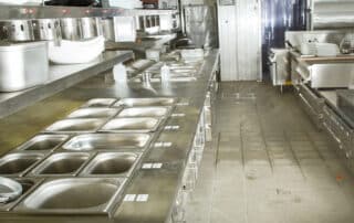Advanced Restoration of Colorado shares Tips on Handling a Flooded Commercial Kitchen. Stainless steel equipment shown in a water-damaged kitchen.