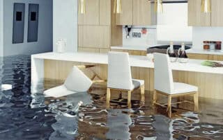 A flooded kitchen with a floating chair and water damage, emphasizing the need for water removal services to quickly extract water and prevent further damage.