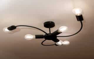 Modern black ceiling light fixture with five exposed bulbs