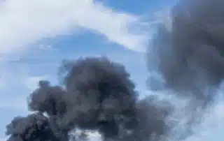 Wildfire smoke vs structure smoke showing different particle types released by burning vegetation and man made materials, comparing size, composition, and health impacts from fine particulate matter and toxic chemicals in the air.